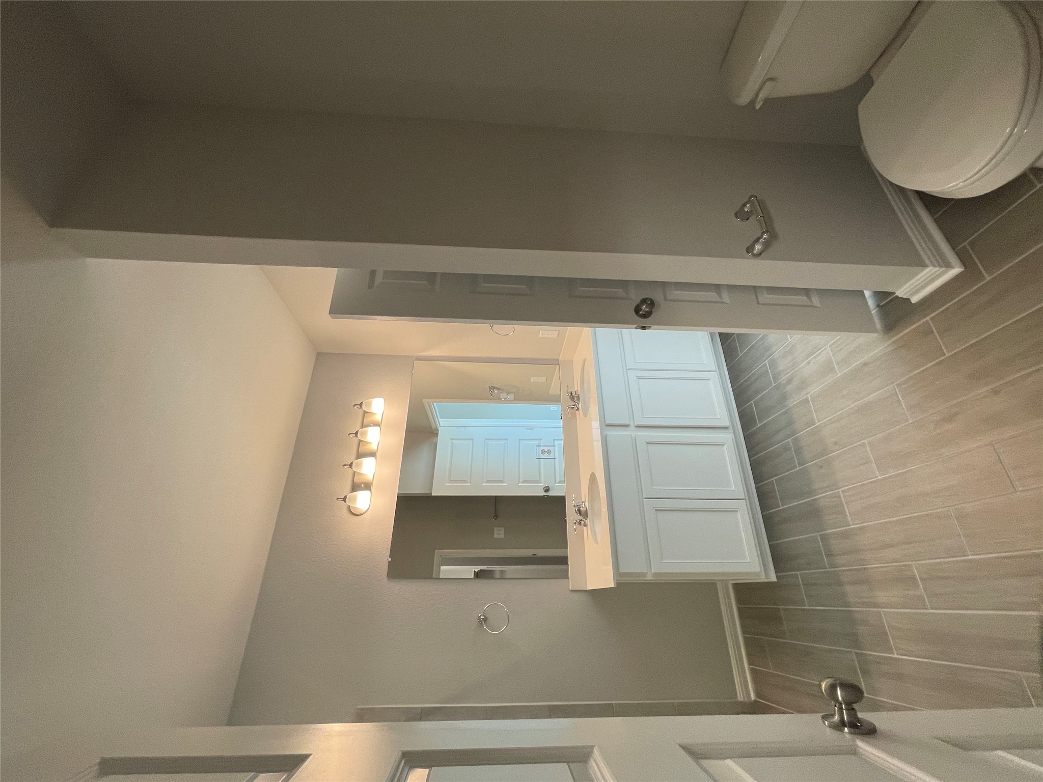 125 Unforgiven Lane Jarrell, TX 76537 - Photo 5 of 17 Bathroom featuring wood tiled floors and double vanity