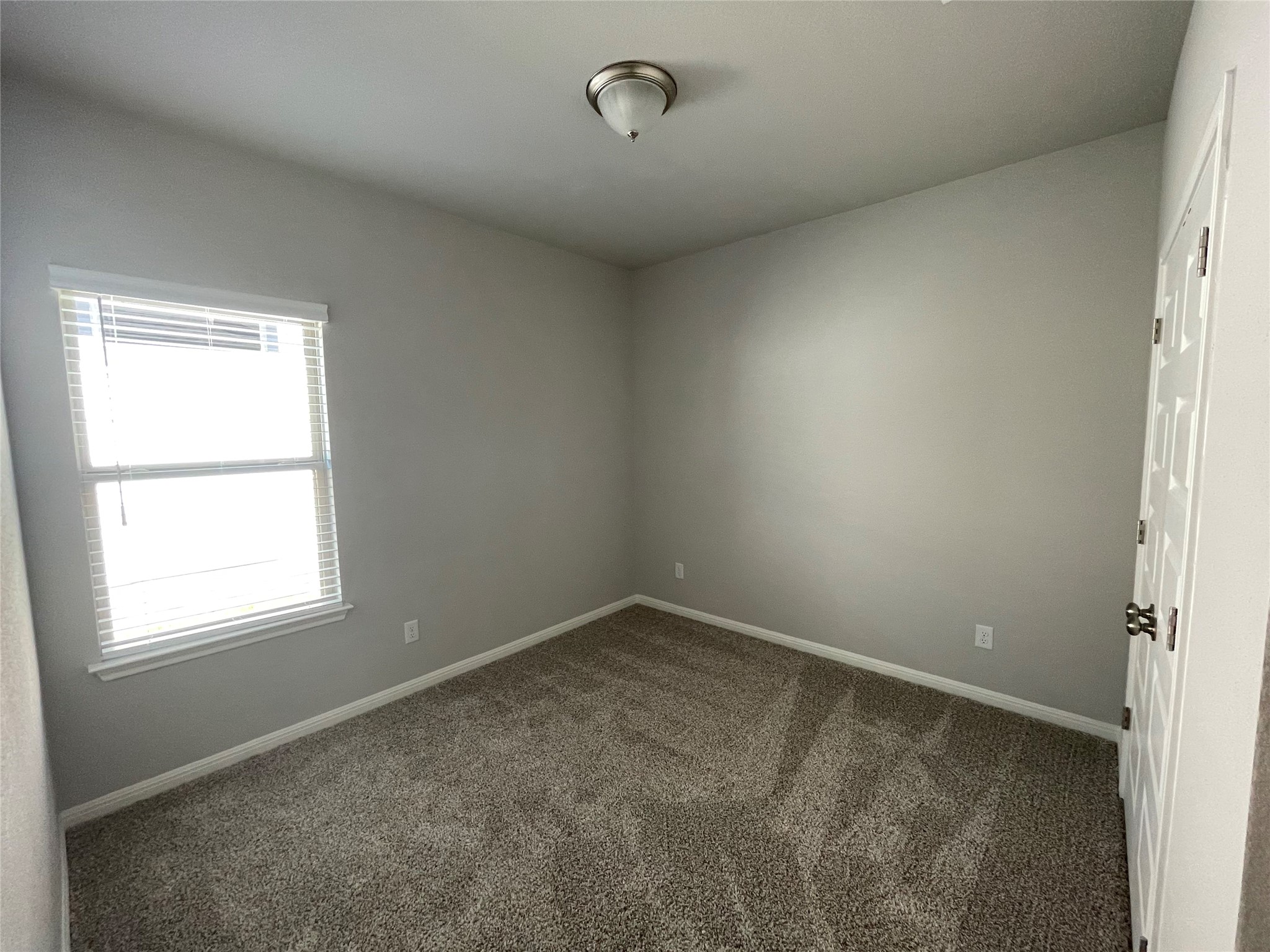 125 Unforgiven Lane Jarrell, TX 76537 - Photo 9 of 17 Empty room with baseboards and dark colored carpet