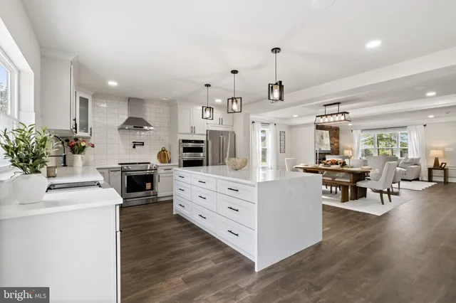 a kitchen with white cabinets and stove