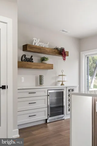 a kitchen with a stove and wooden floor