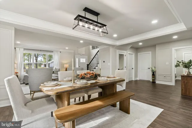 a dining room with furniture and wooden floor
