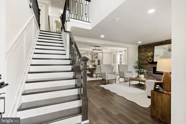 a living room with furniture a fireplace and a large window