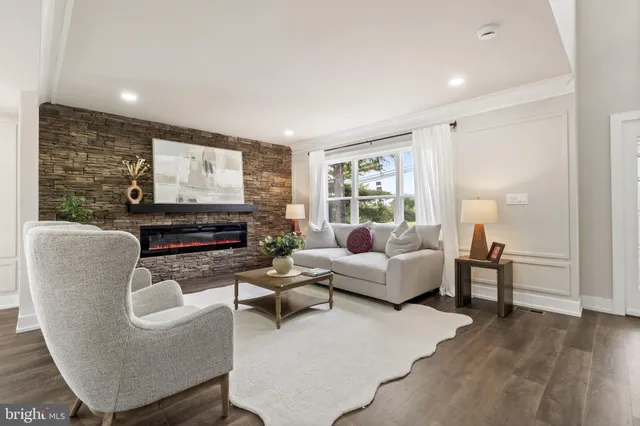 a hallway with white doors wooden floor and stairs