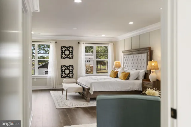 a spacious bathroom with a double vanity sink toilet mirror and shower