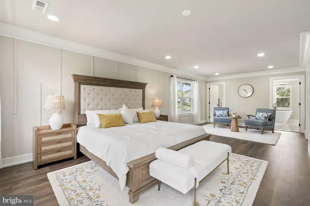 a large bedroom with a bed and a couch