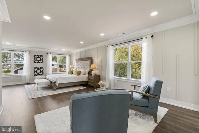 a bathroom with a toilet sink double vanity and bathtub