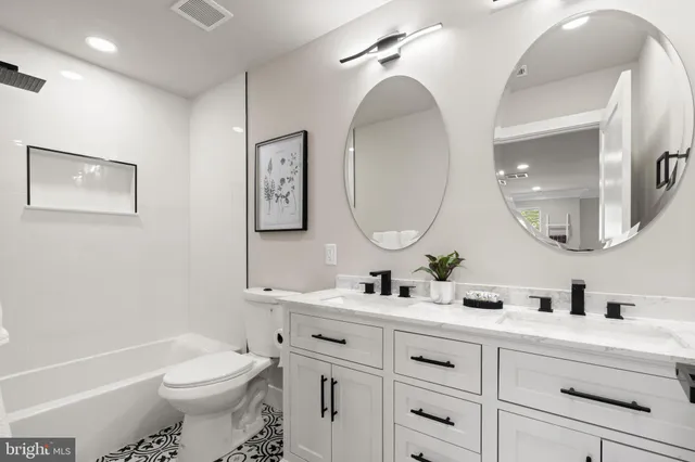 a view of a house with a yard and a large tree