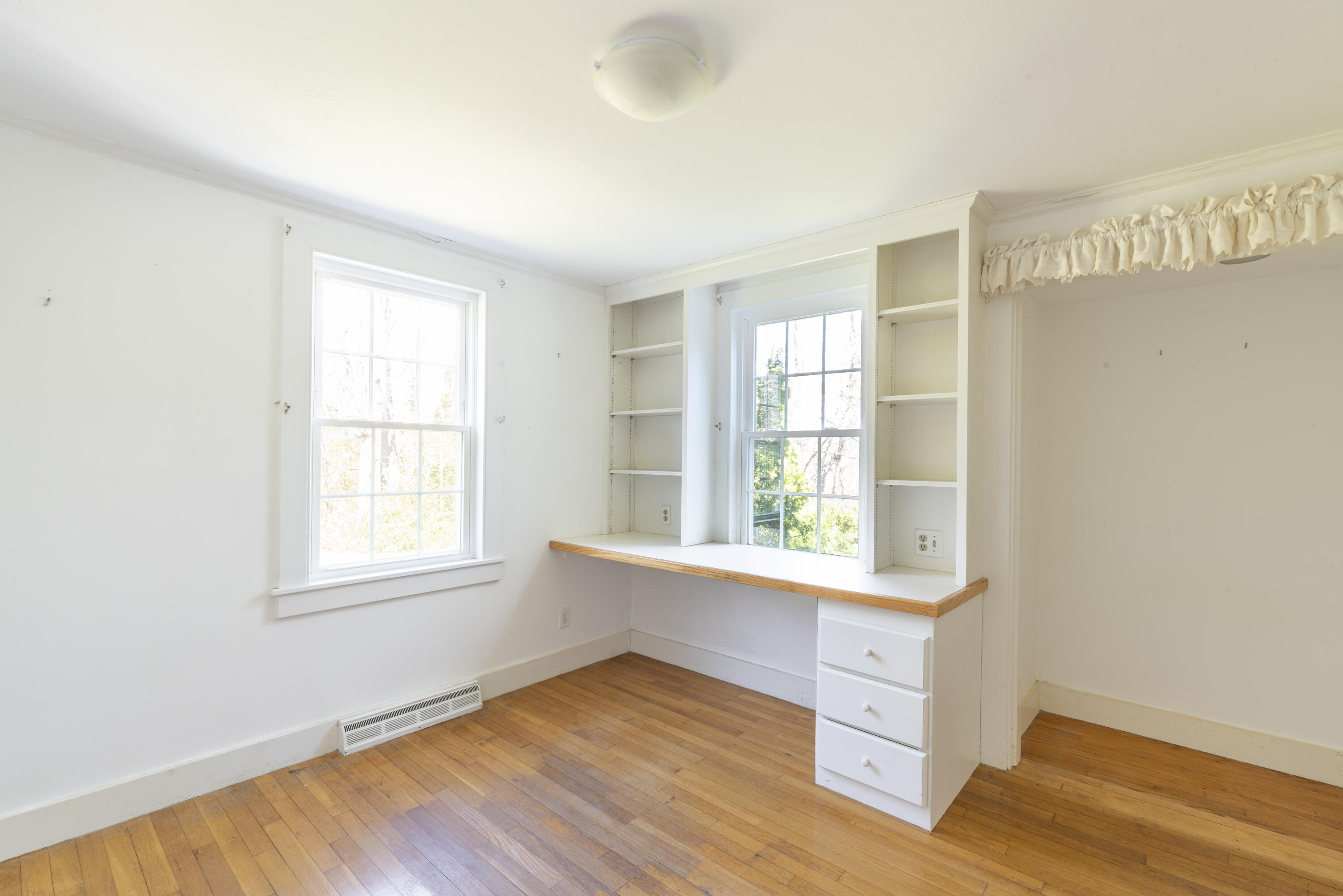 2955 Main Street Barnstable, MA 02630 - Photo 28 of 35 an empty room with wooden floor and windows