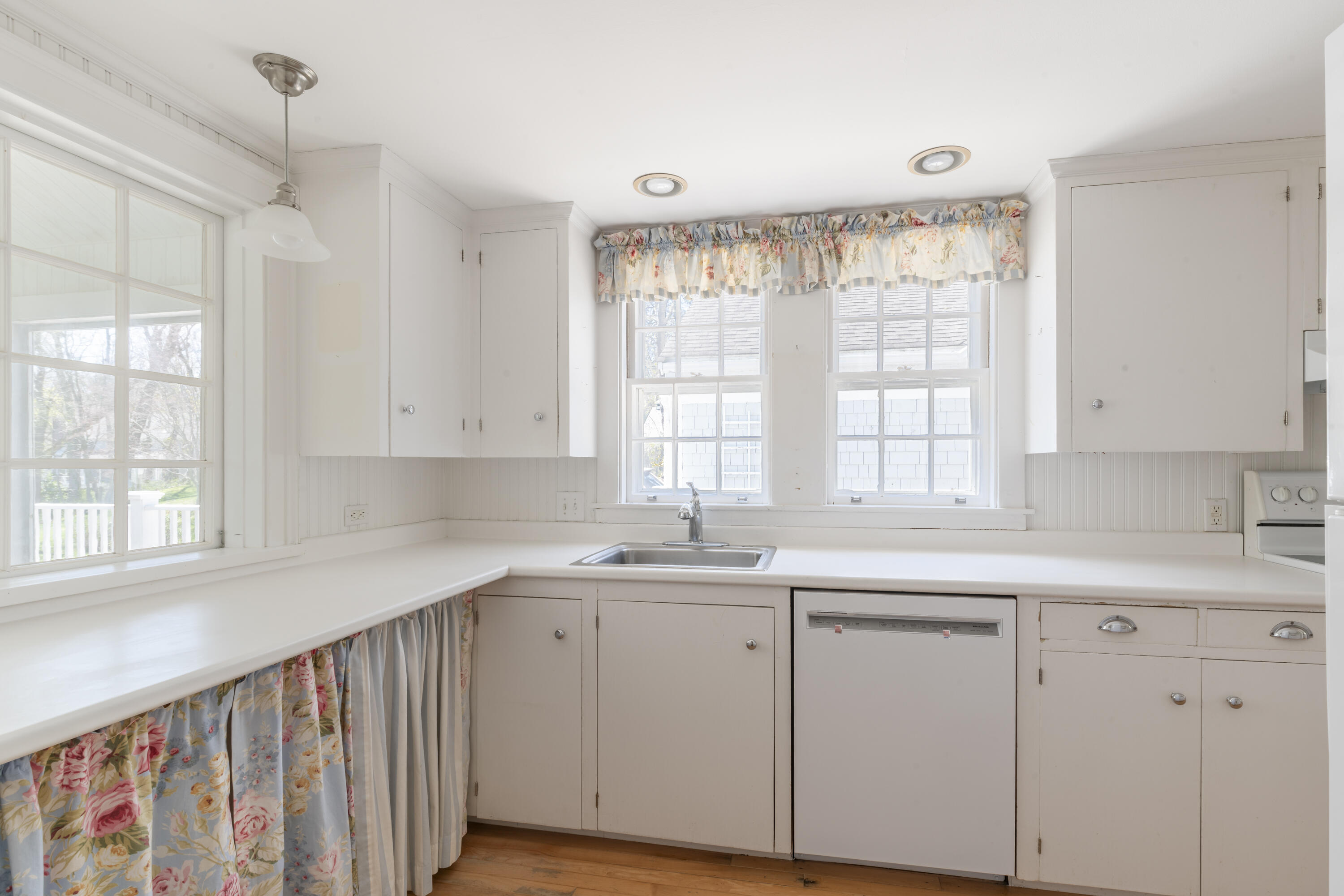 2955 Main Street Barnstable, MA 02630 - Photo 9 of 35 a kitchen with white cabinets window and sink