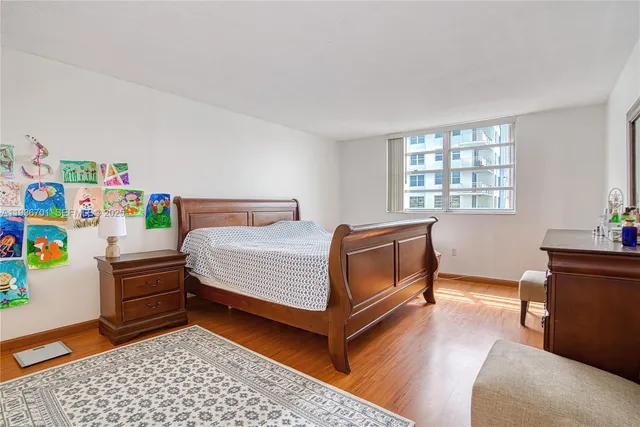 a bedroom with a bed and a desk in it