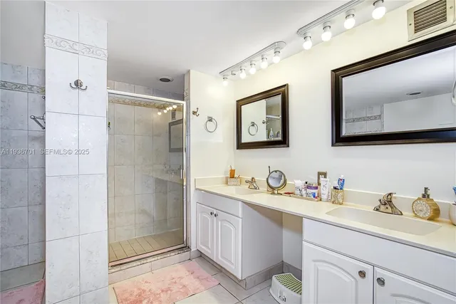 a bathroom with a double vanity sink mirror and