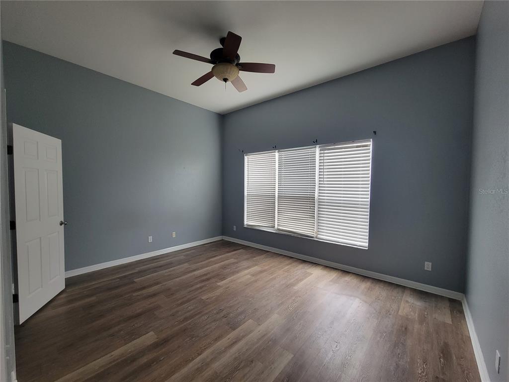 2734 Rochelle Drive Winter Haven, FL 33881 - Photo 16 of 38 a view of empty room with wooden floor and fan