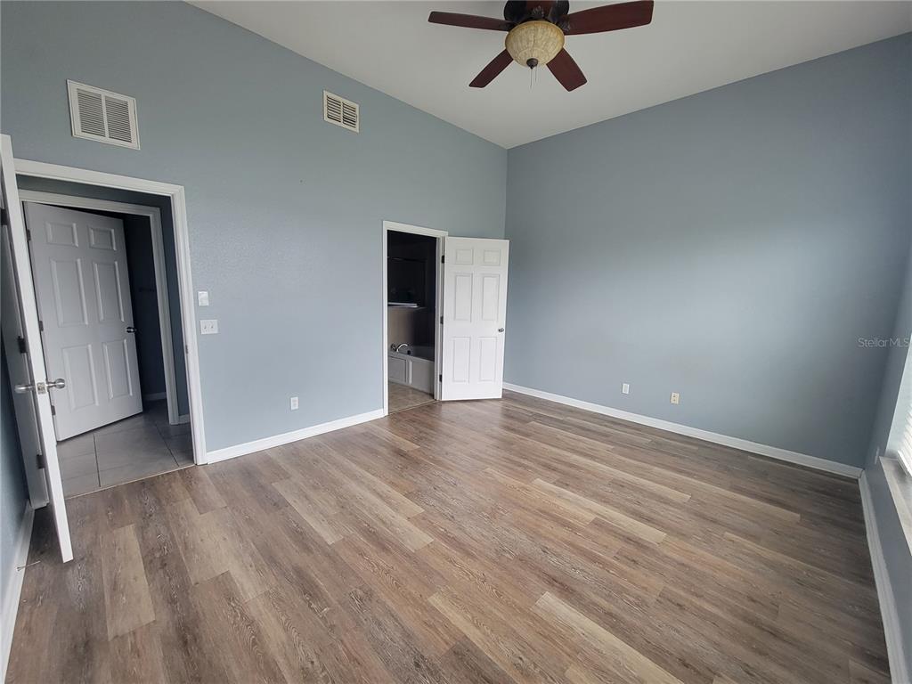 2734 Rochelle Drive Winter Haven, FL 33881 - Photo 17 of 38 wooden floor in an empty room with a window