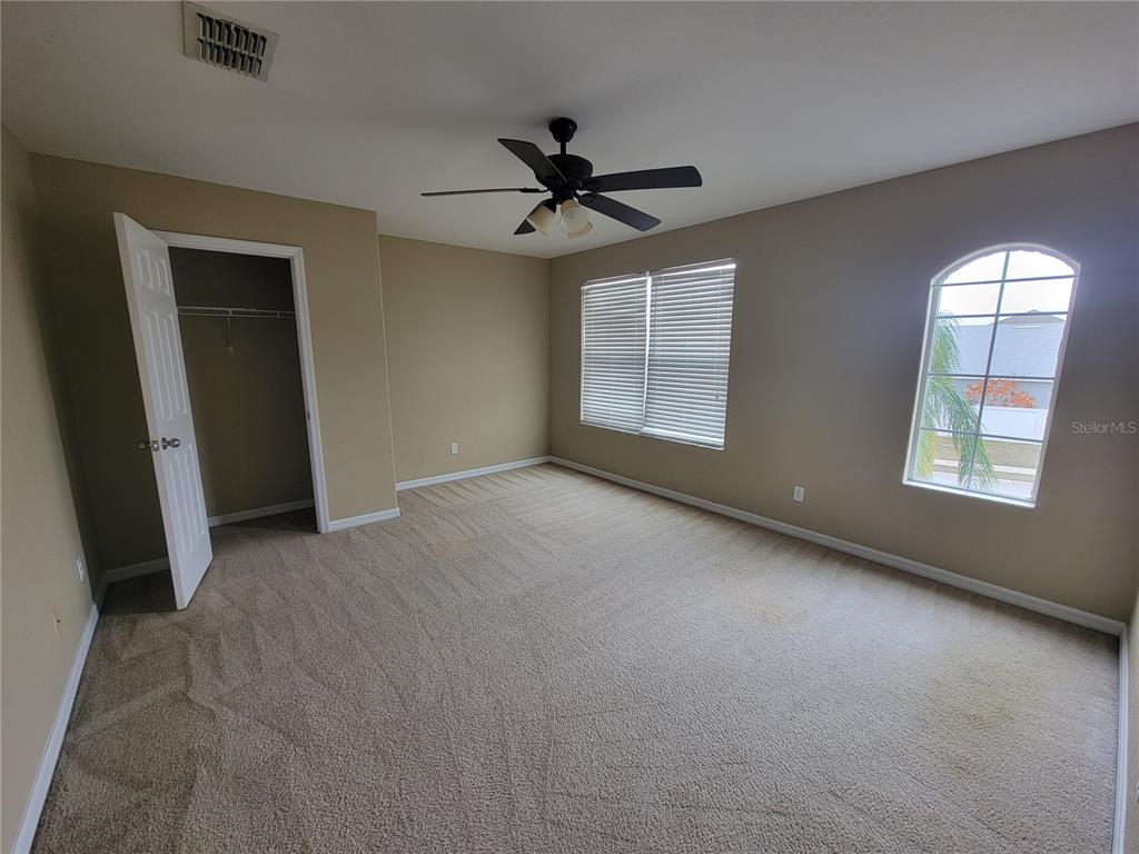 2734 Rochelle Drive Winter Haven, FL 33881 - Photo 30 of 38 an empty room with chandelier fan and windows