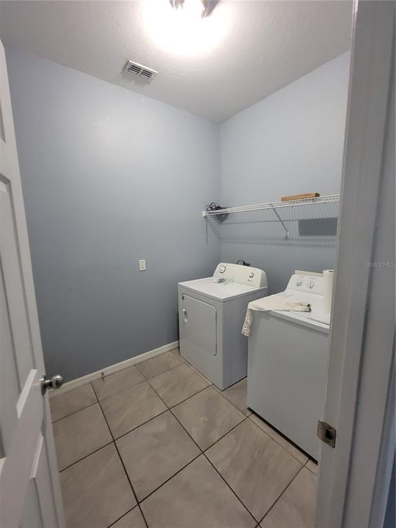 2734 Rochelle Drive Winter Haven, FL 33881 - Photo 34 of 38 a utility room with dryer and washer