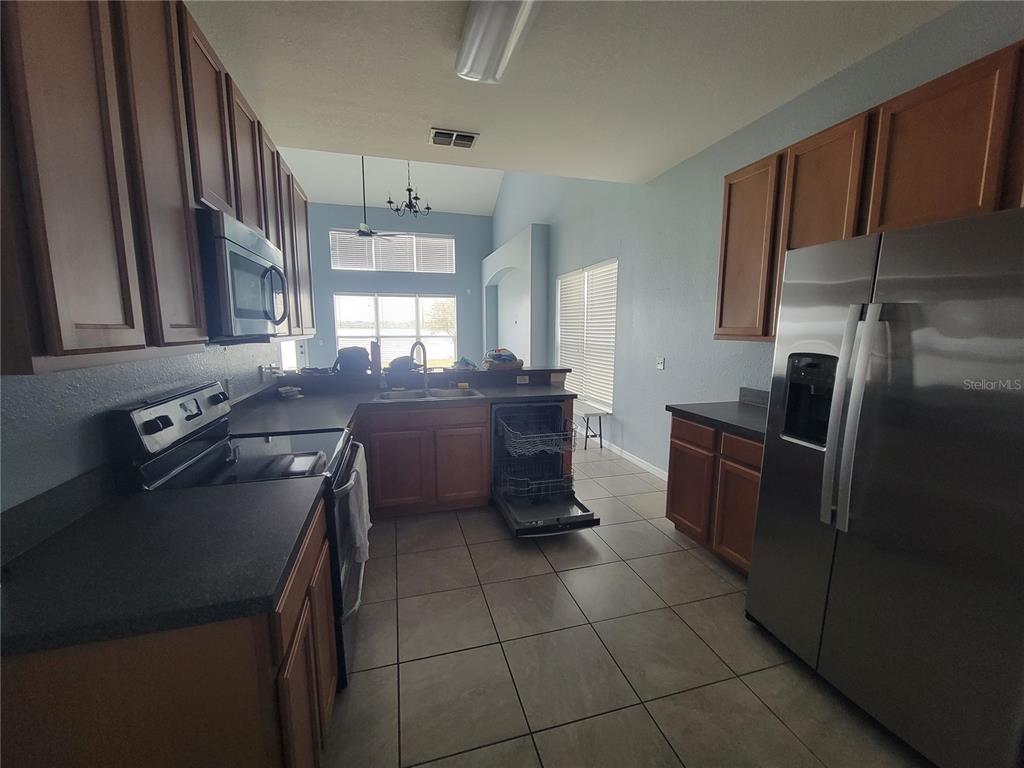 2734 Rochelle Drive Winter Haven, FL 33881 - Photo 5 of 38 a kitchen with a sink appliances and cabinets