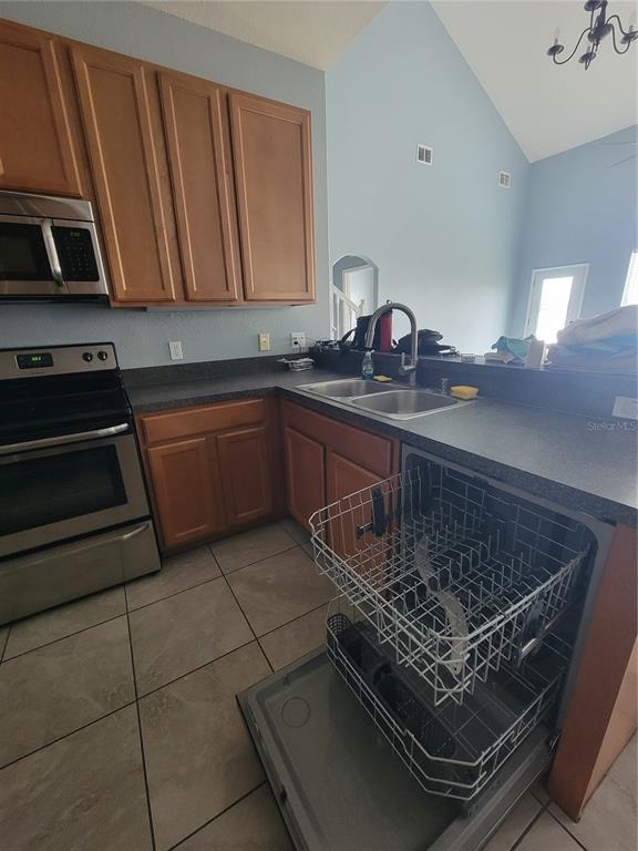 2734 Rochelle Drive Winter Haven, FL 33881 - Photo 7 of 38 a kitchen with a sink a stove and cabinets