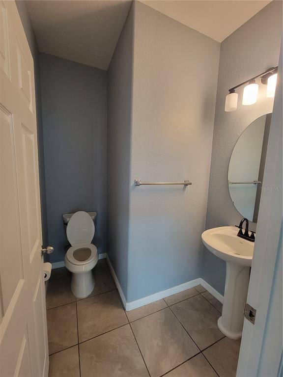 2734 Rochelle Drive Winter Haven, FL 33881 - Photo 10 of 38 a white toilet sitting next to a bathroom sink