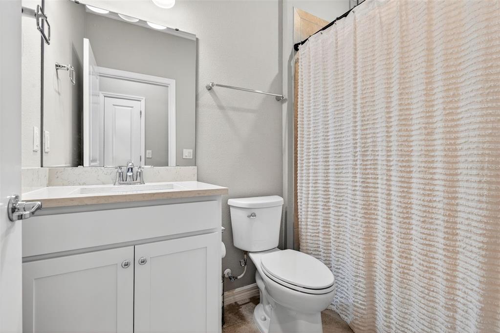 6427 Mooring Line Circle Apollo Beach, FL 33572 - Photo 23 of 34 a bathroom with a sink a toilet and shower curtain