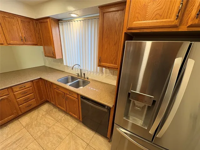 a kitchen with a sink and a refrigerator