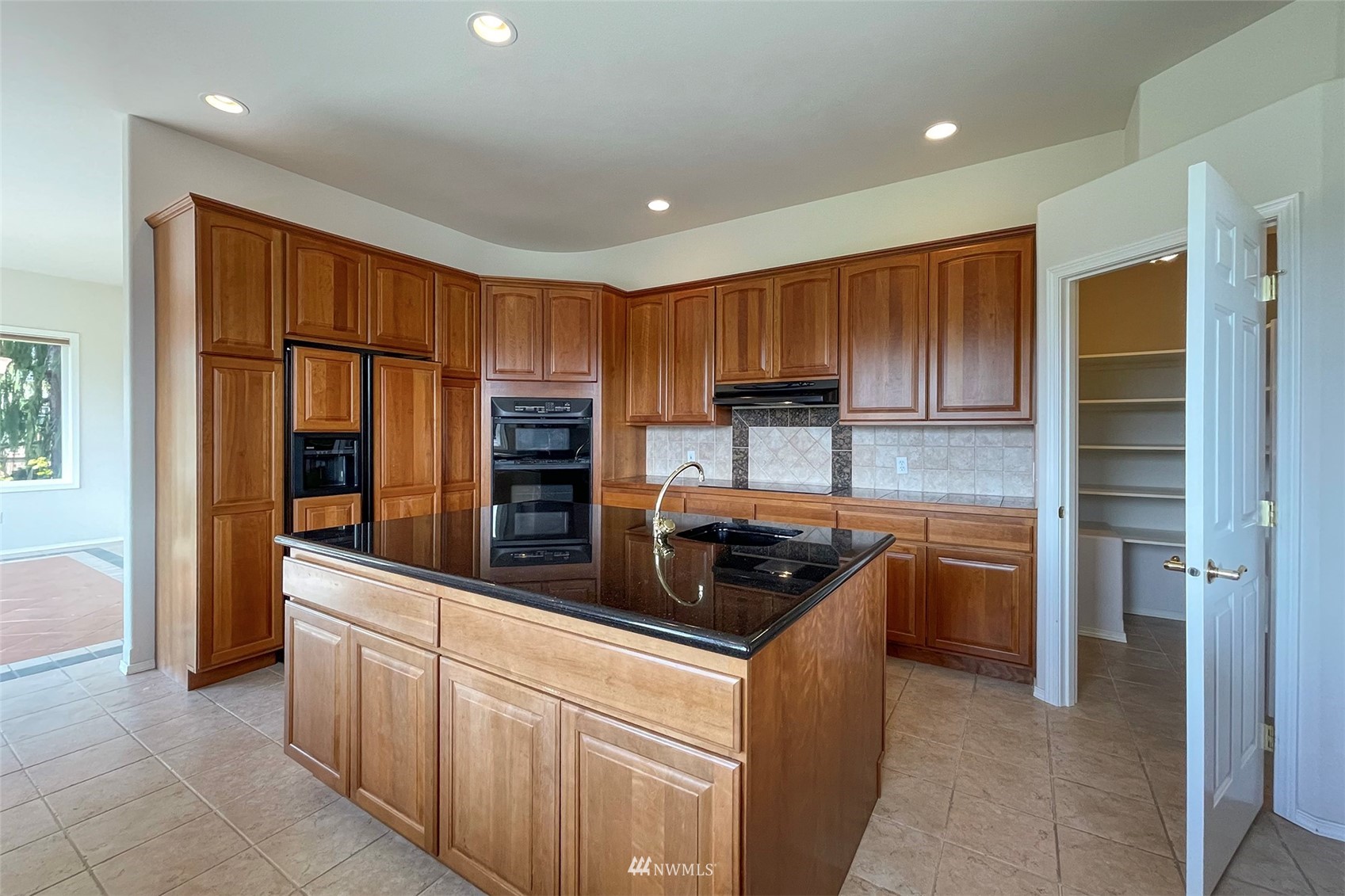 402 Marine Drive Sequim, WA 98382 - Photo 12 of 40 a kitchen with stainless steel appliances granite countertop a refrigerator and a stove top oven