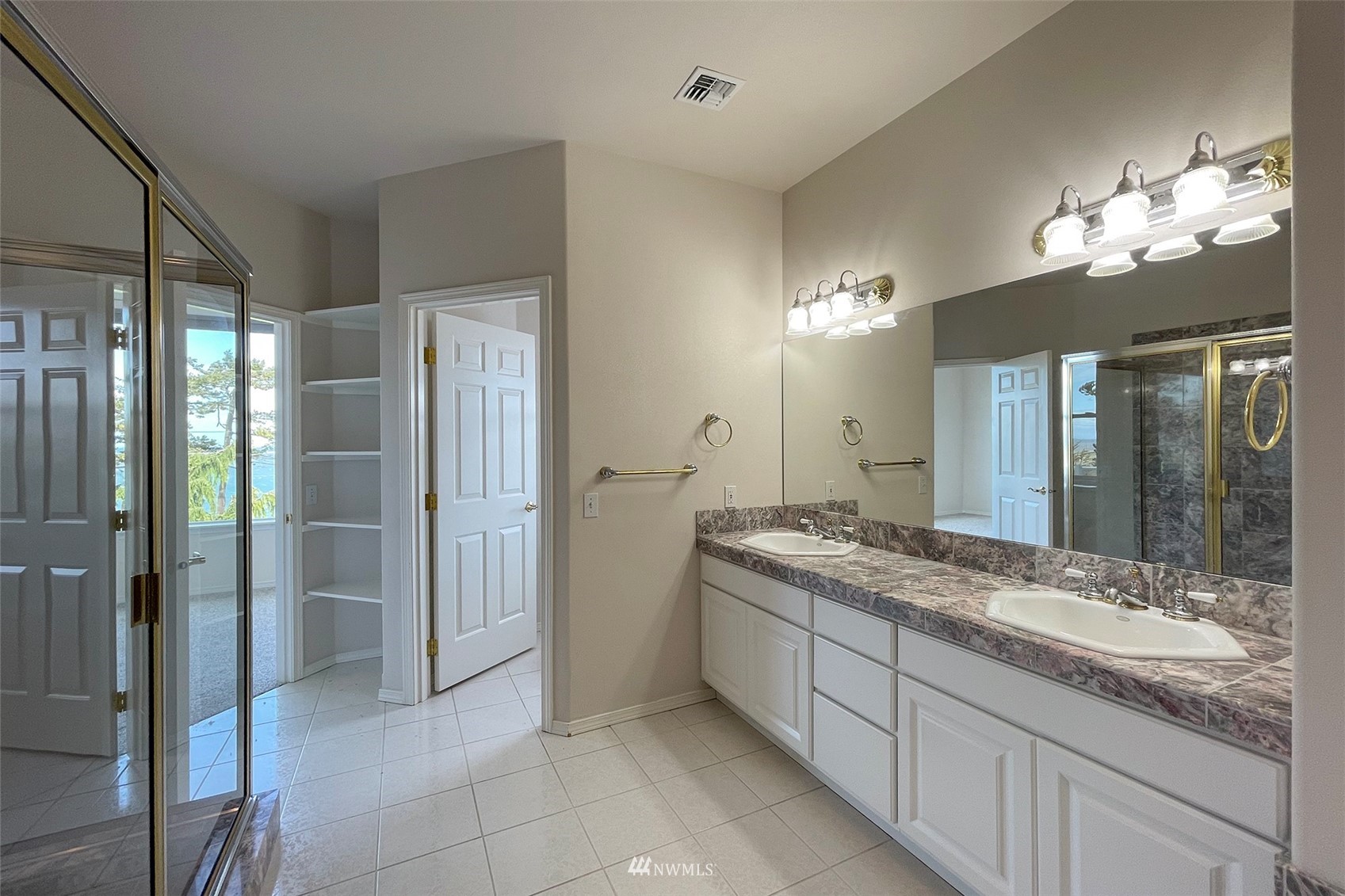 402 Marine Drive Sequim, WA 98382 - Photo 21 of 40 a bathroom with a granite countertop sink a mirror and a shower