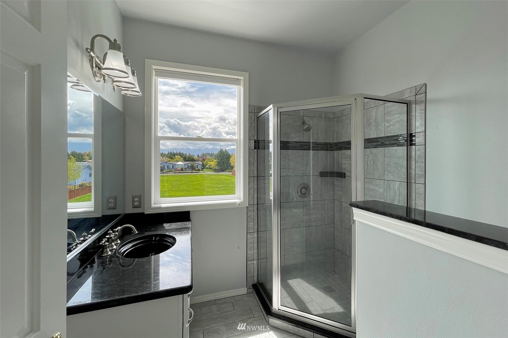 402 Marine Drive Sequim, WA 98382 - Photo 24 of 40 a bathroom with a sink a mirror and a shower