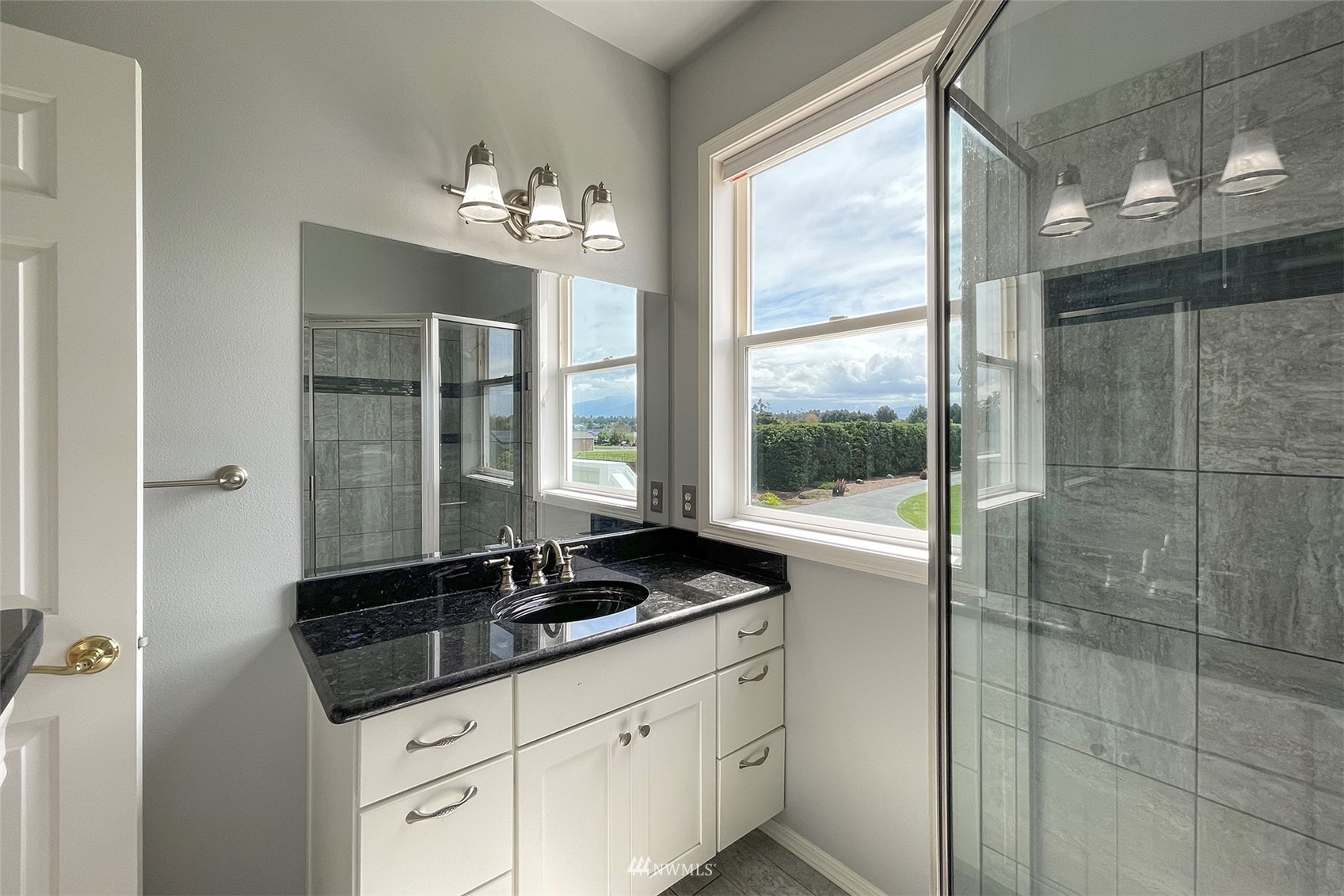 402 Marine Drive Sequim, WA 98382 - Photo 25 of 40 a bathroom with a sink and a large mirror