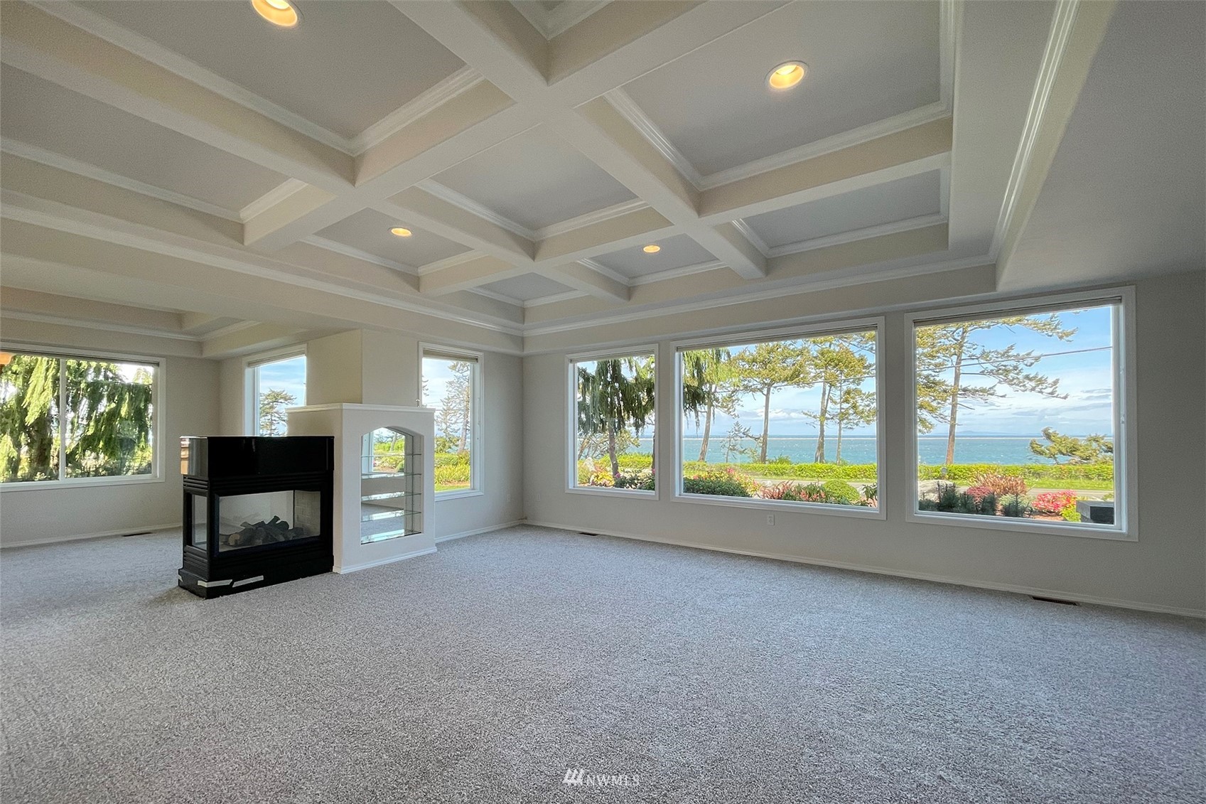 402 Marine Drive Sequim, WA 98382 - Photo 7 of 40 a view of an empty room with a fireplace and a large window