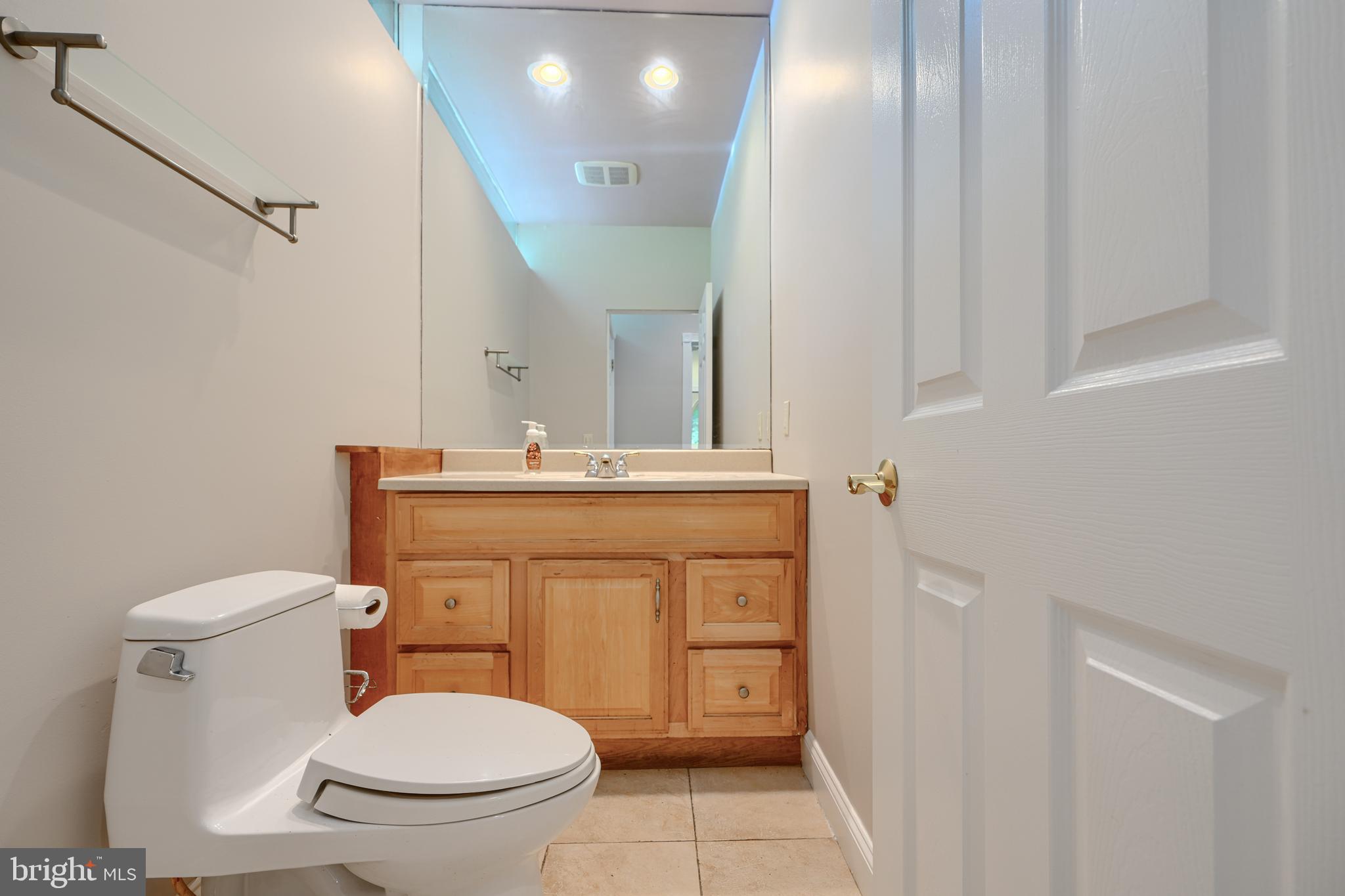 2101 Tufton Avenue Reisterstown, MD 21136 - Photo 46 of 125 a bathroom with a toilet sink vanity and mirror