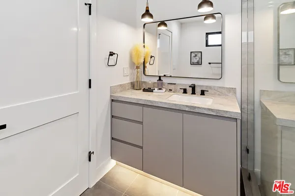 a bathroom with a double vanity sink and mirror