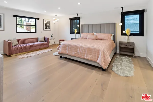 a bedroom with a bed and a couch