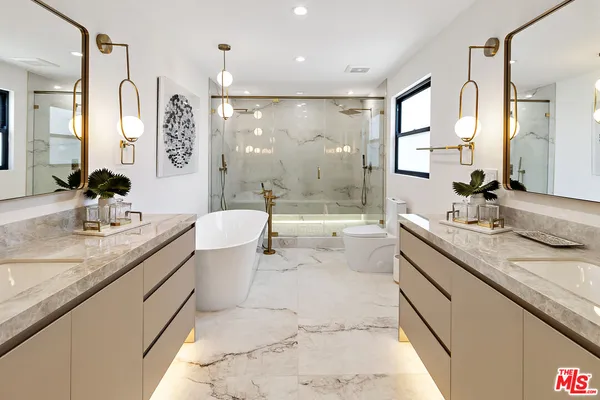 a bathroom with a granite countertop sink mirror and a bathtub