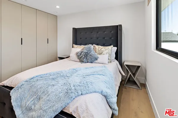 a bed sitting in a bedroom next to a window