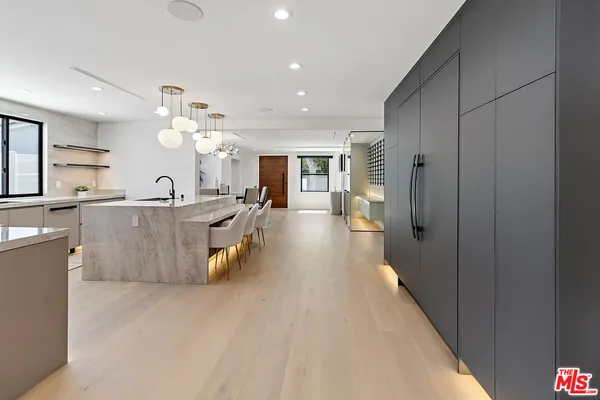 a large room with lots of counter space and painting on the wall