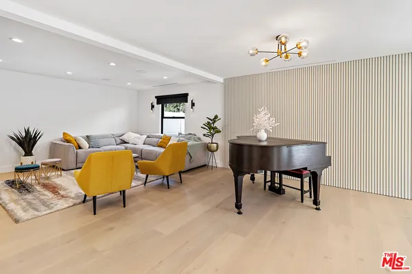 a living room with furniture and a lamp