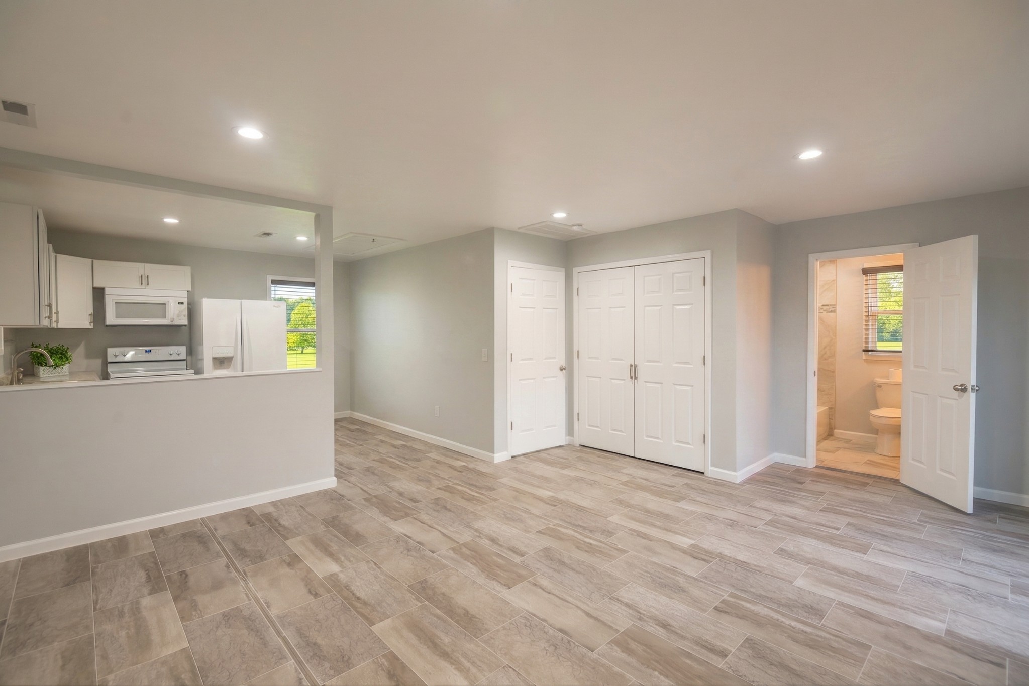 28 Henderson Road Lynchburg, TN 37352 - Photo 63 of 87 a view of an empty room and kitchen with wooden floor
