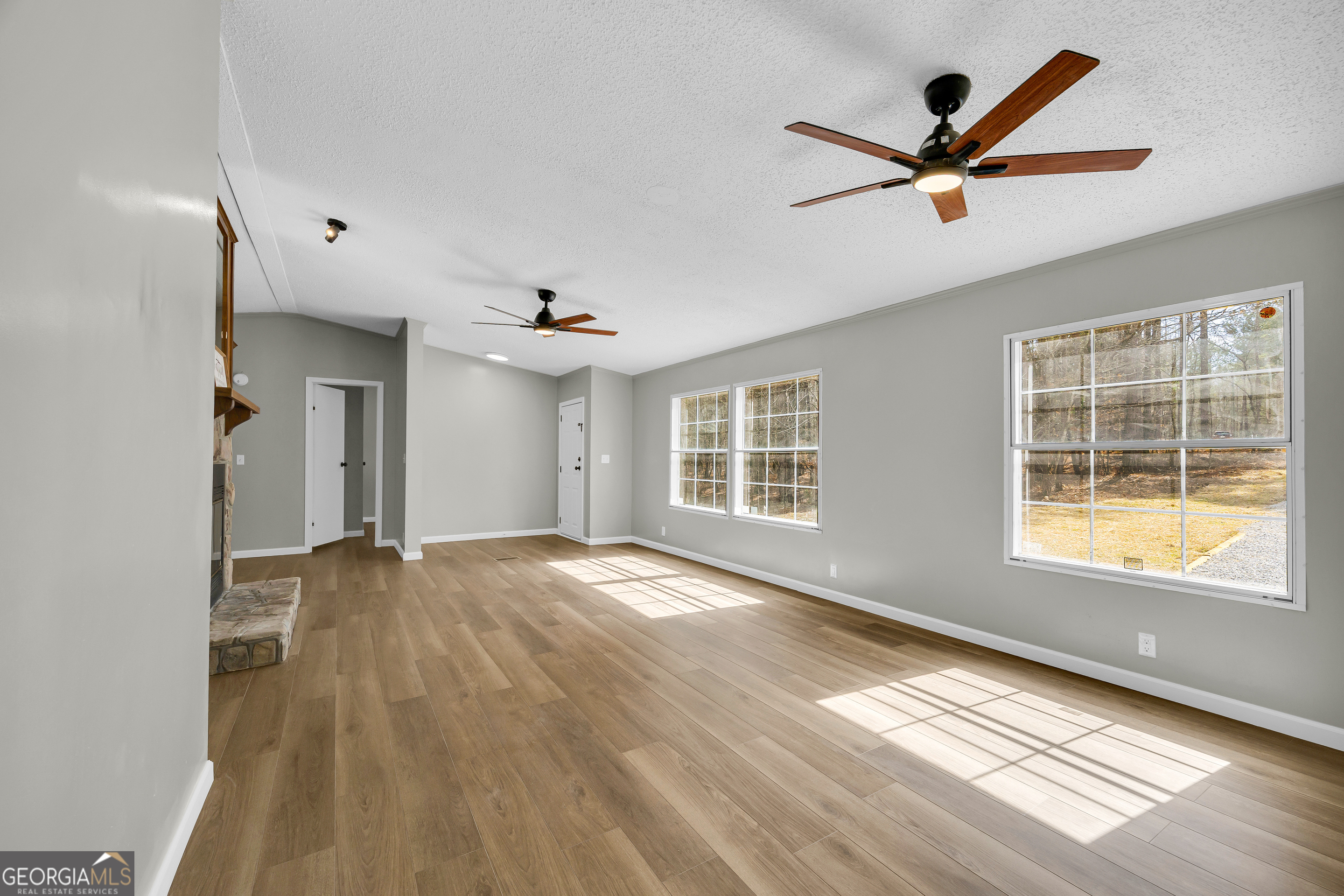 60 Tribble Bottoms Road Arnoldsville, GA 30619 - Photo 12 of 66 a view of an empty room with wooden floor and a window