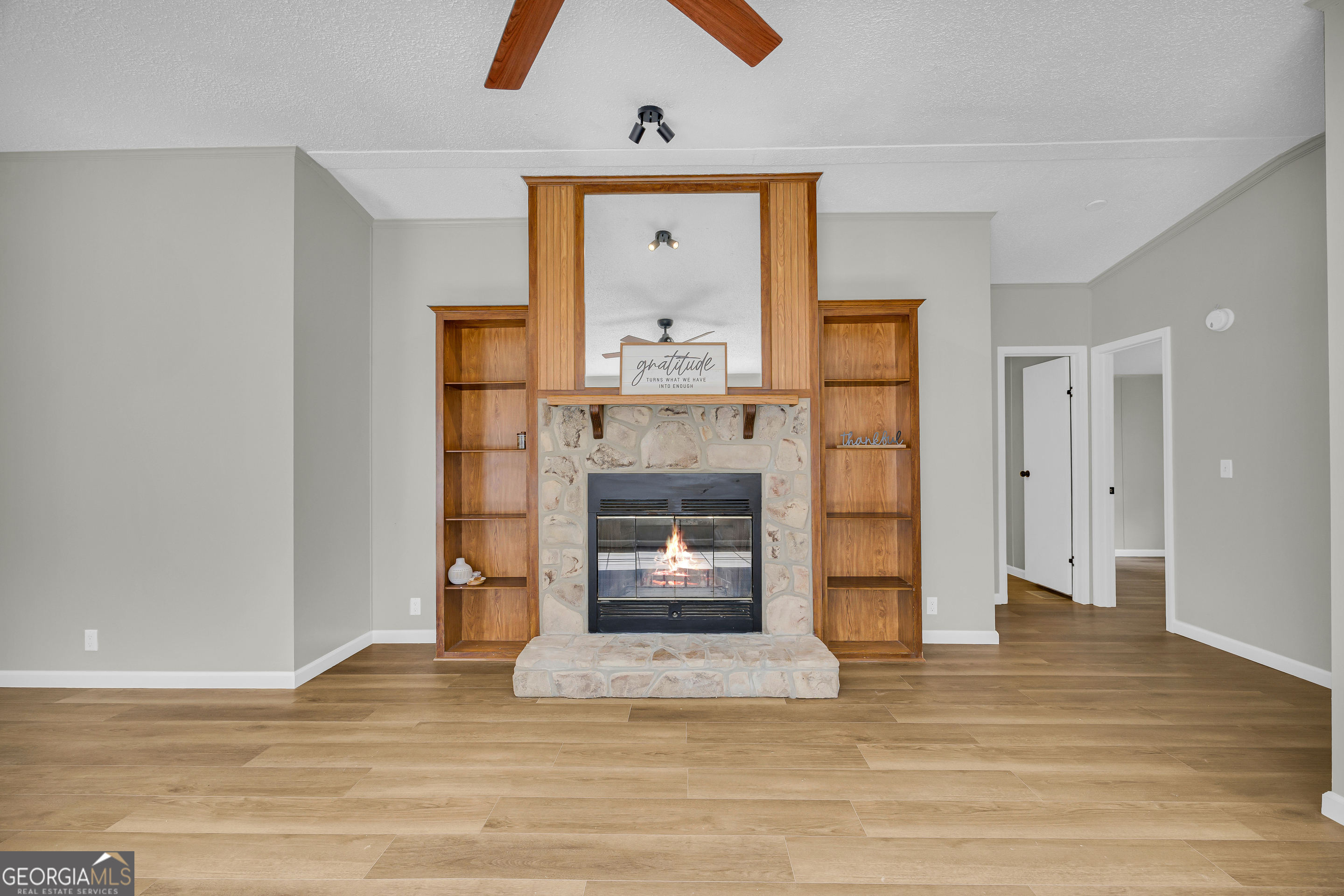 60 Tribble Bottoms Road Arnoldsville, GA 30619 - Photo 13 of 66 a view of a livingroom with a fireplace a fireplace and wooden floor
