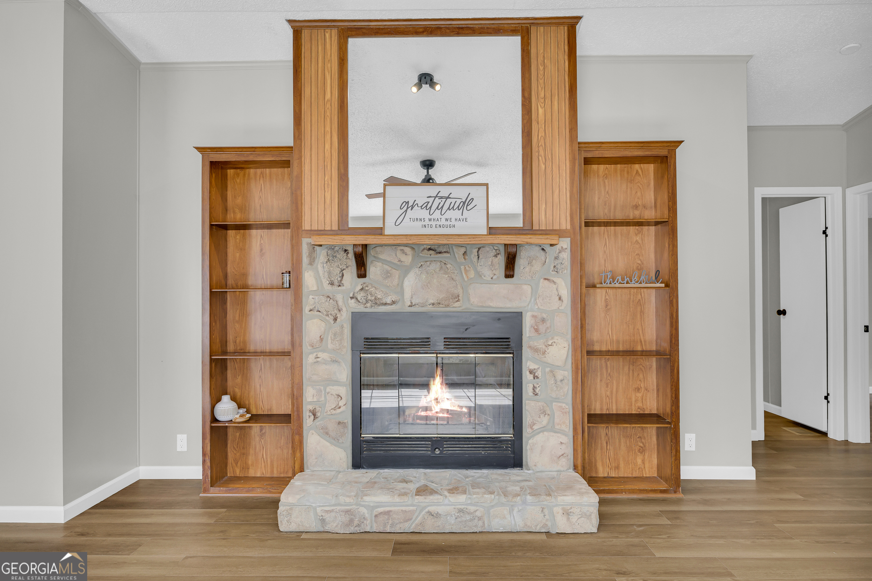 60 Tribble Bottoms Road Arnoldsville, GA 30619 - Photo 14 of 66 a living room with a fireplace and a wooden floor
