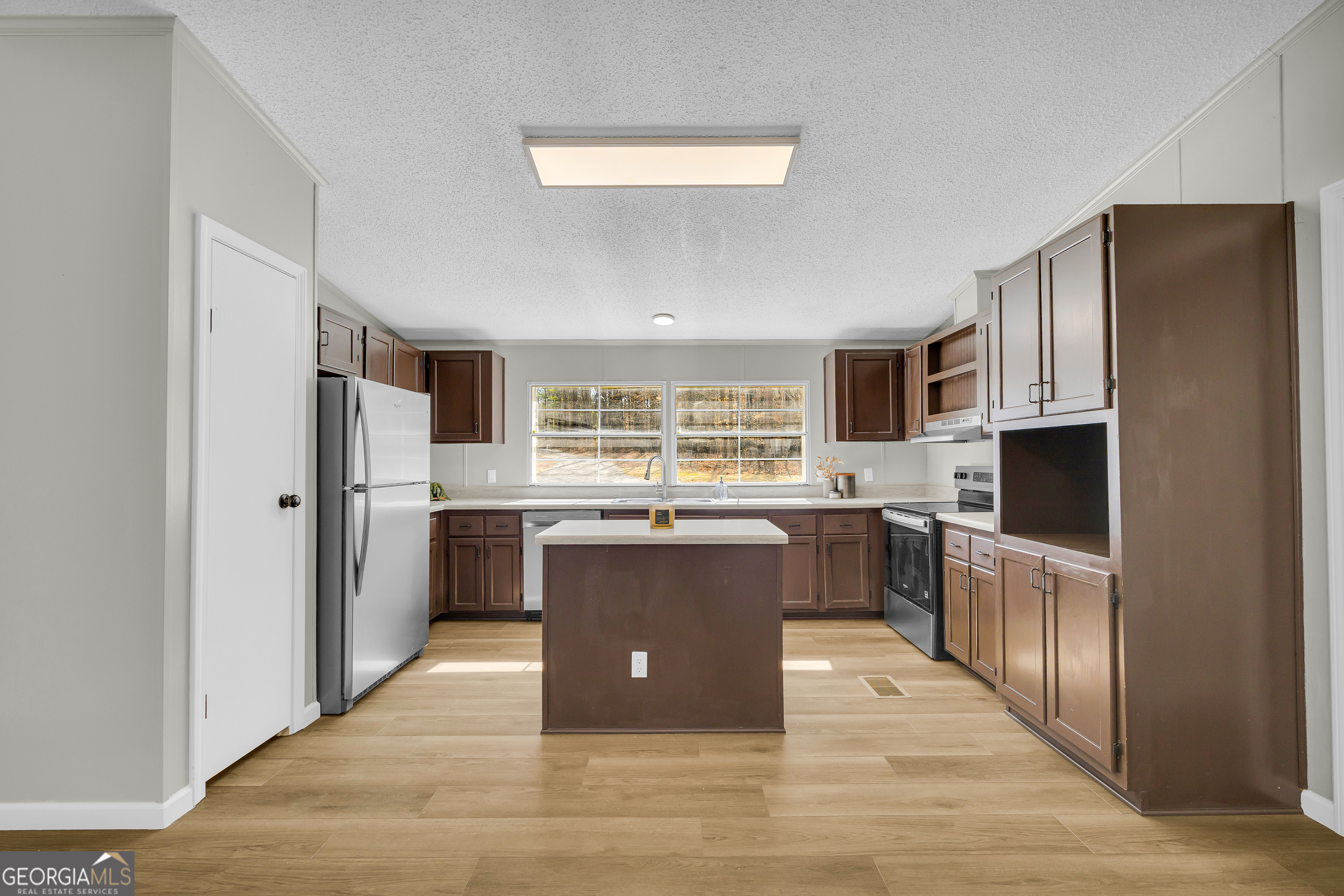 60 Tribble Bottoms Road Arnoldsville, GA 30619 - Photo 15 of 66 a kitchen with stainless steel appliances granite countertop a refrigerator and a stove top oven