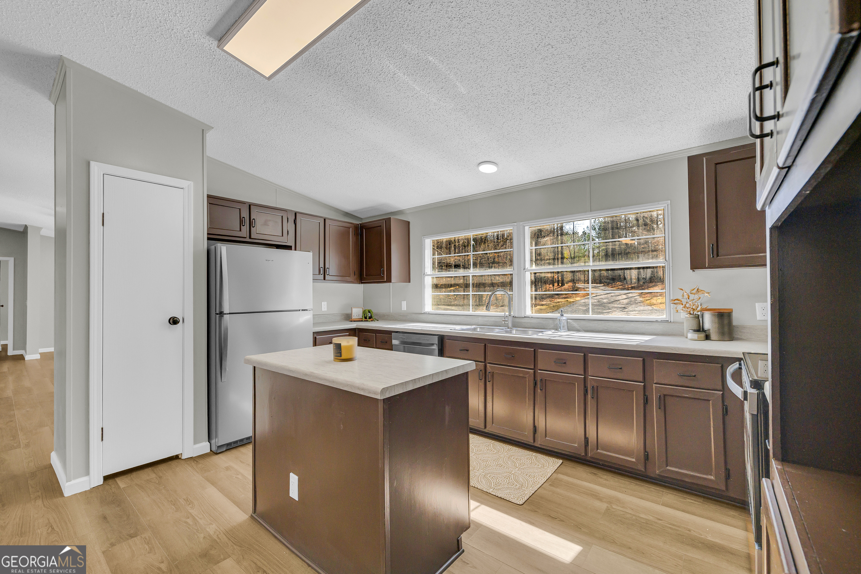 60 Tribble Bottoms Road Arnoldsville, GA 30619 - Photo 17 of 66 a kitchen with stainless steel appliances granite countertop a stove a sink a refrigerator and island