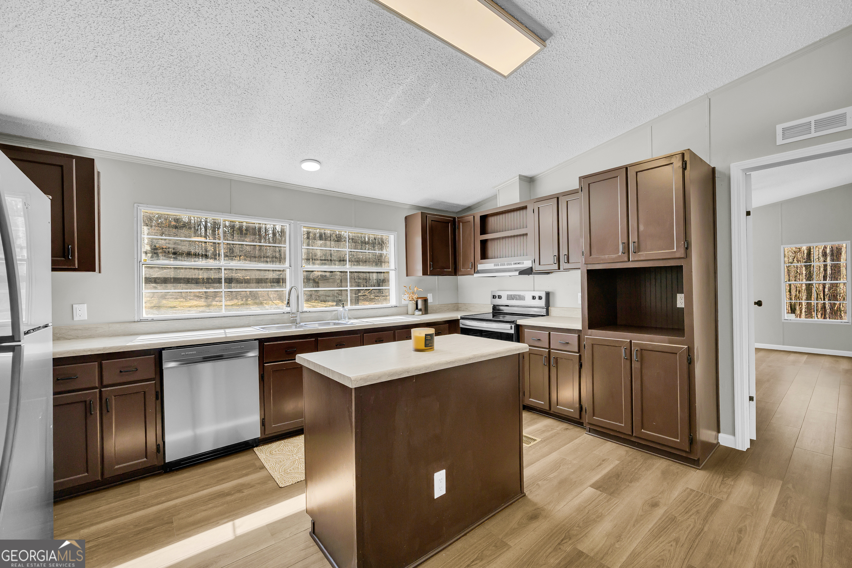 60 Tribble Bottoms Road Arnoldsville, GA 30619 - Photo 18 of 66 a kitchen with stainless steel appliances granite countertop a sink stove and refrigerator