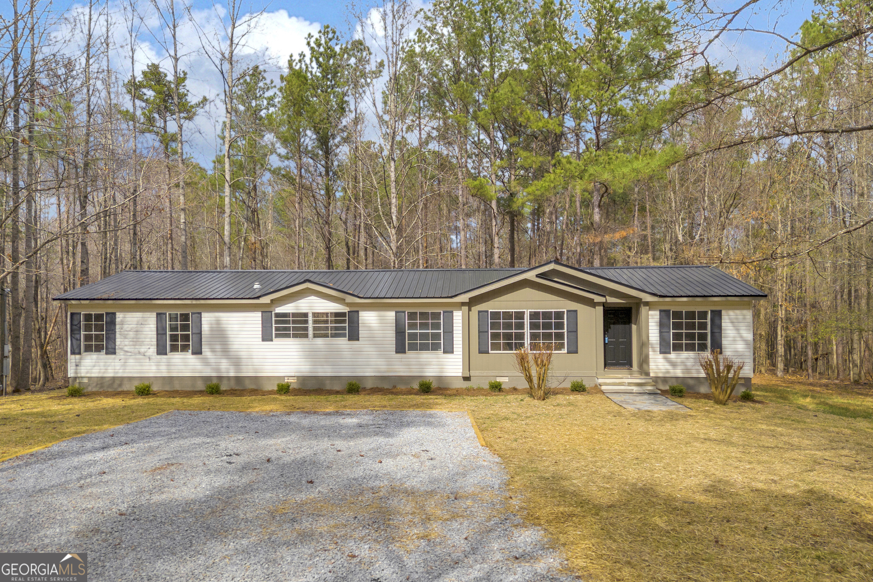 60 Tribble Bottoms Road Arnoldsville, GA 30619 - Photo 2 of 66 a front view of a house with a yard table and chairs