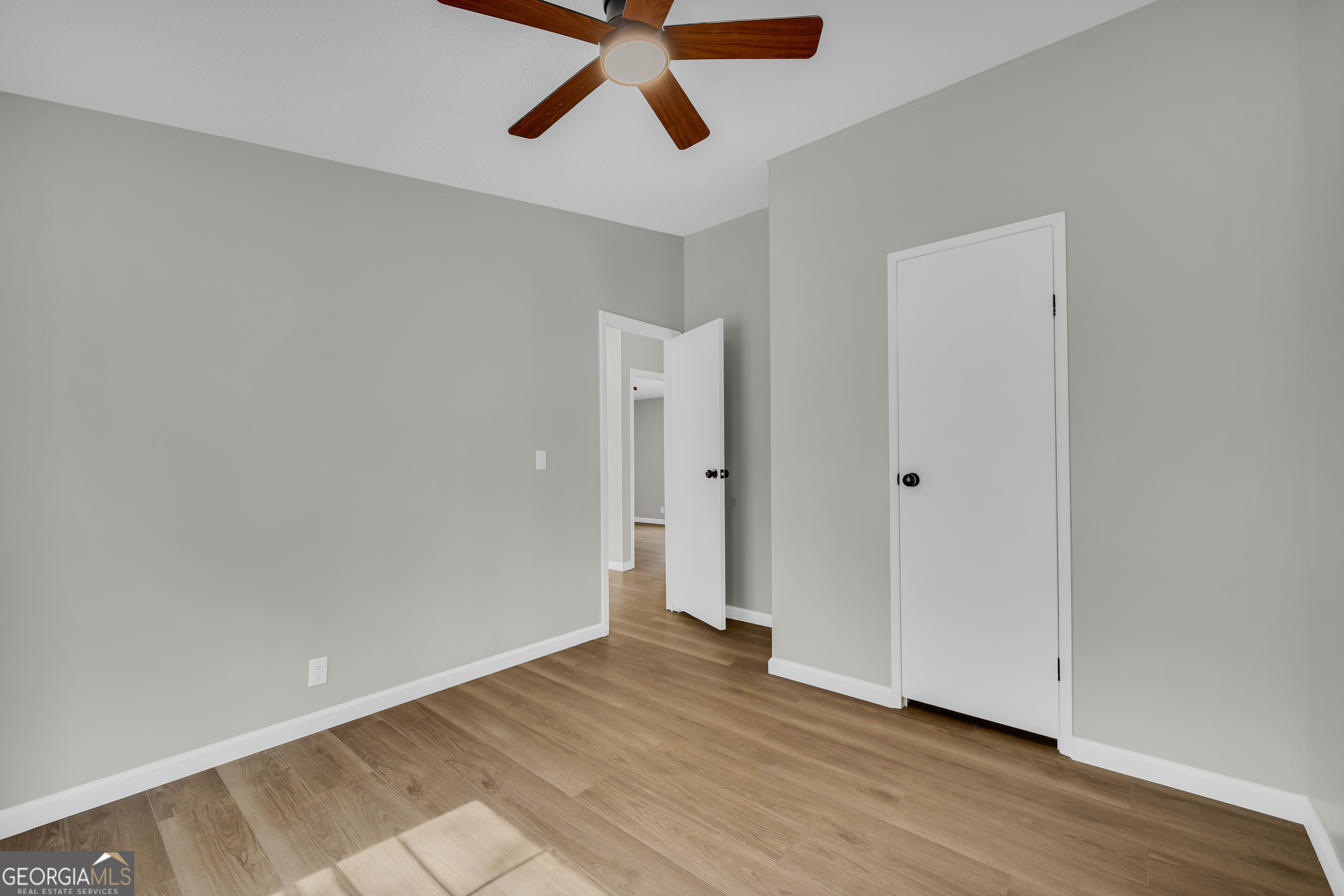 60 Tribble Bottoms Road Arnoldsville, GA 30619 - Photo 23 of 66 an empty room with wooden floor and windows