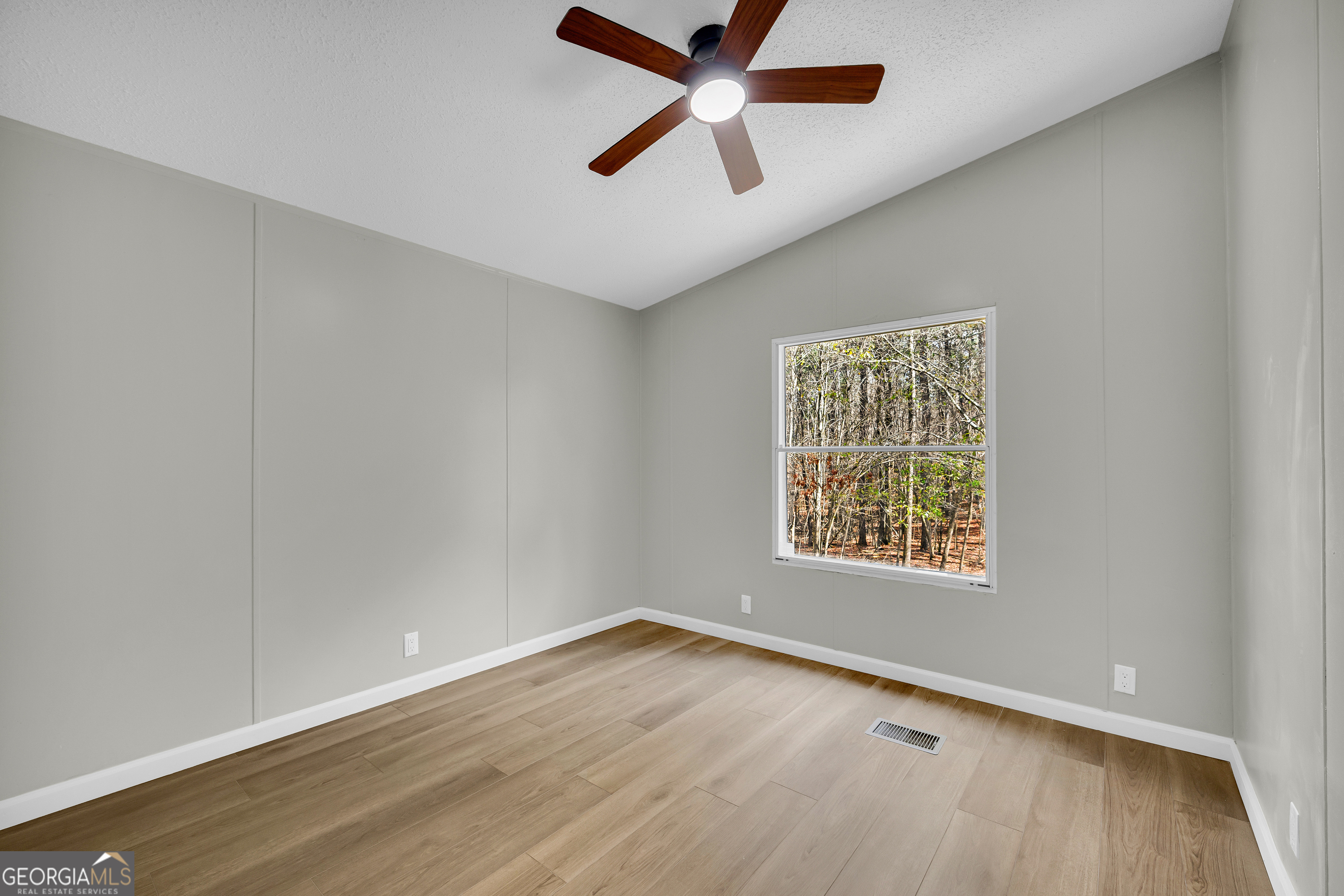 60 Tribble Bottoms Road Arnoldsville, GA 30619 - Photo 24 of 66 an empty room with a window and a ceiling fan