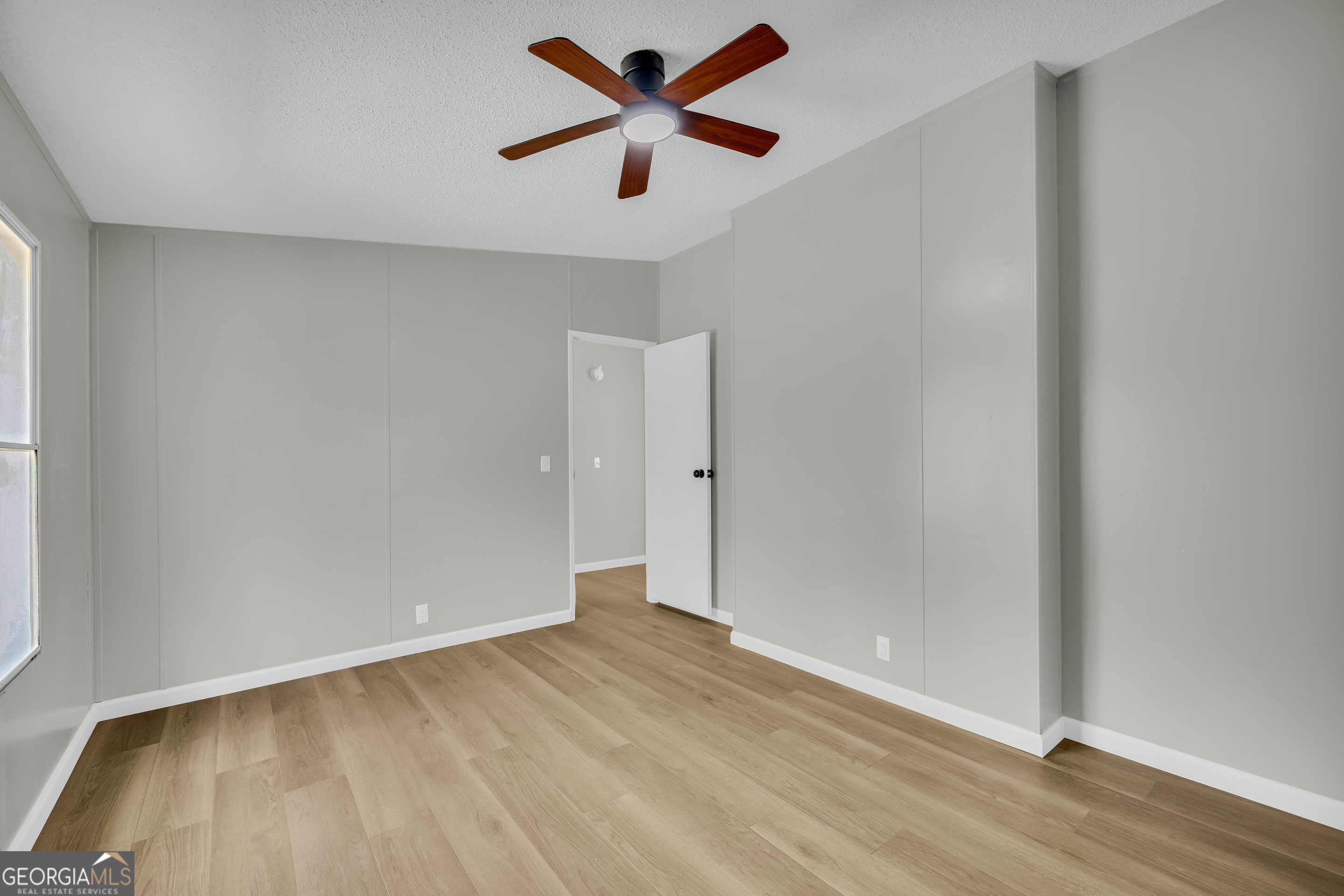 60 Tribble Bottoms Road Arnoldsville, GA 30619 - Photo 27 of 66 an empty room with wooden floor and a ceiling fan