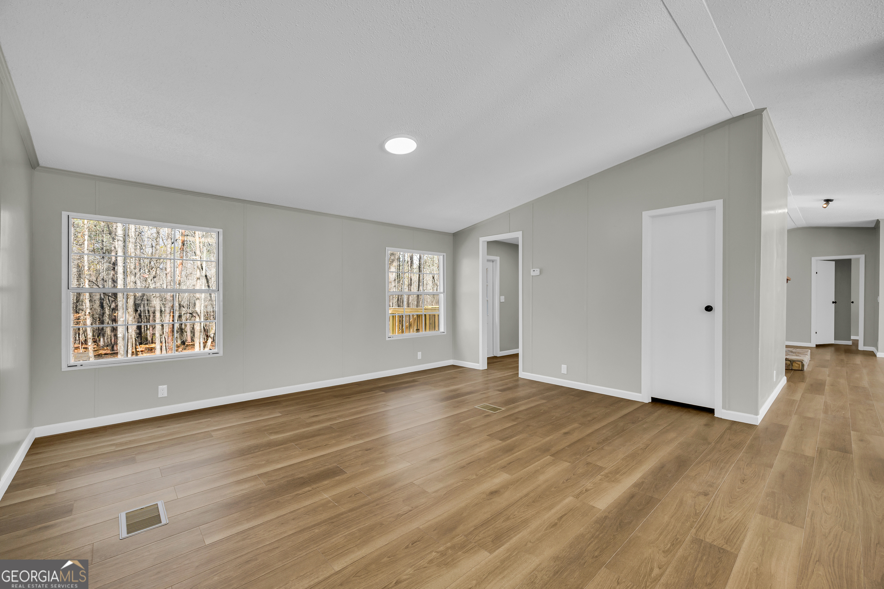 60 Tribble Bottoms Road Arnoldsville, GA 30619 - Photo 29 of 66 a view of an empty room with wooden floor and a window
