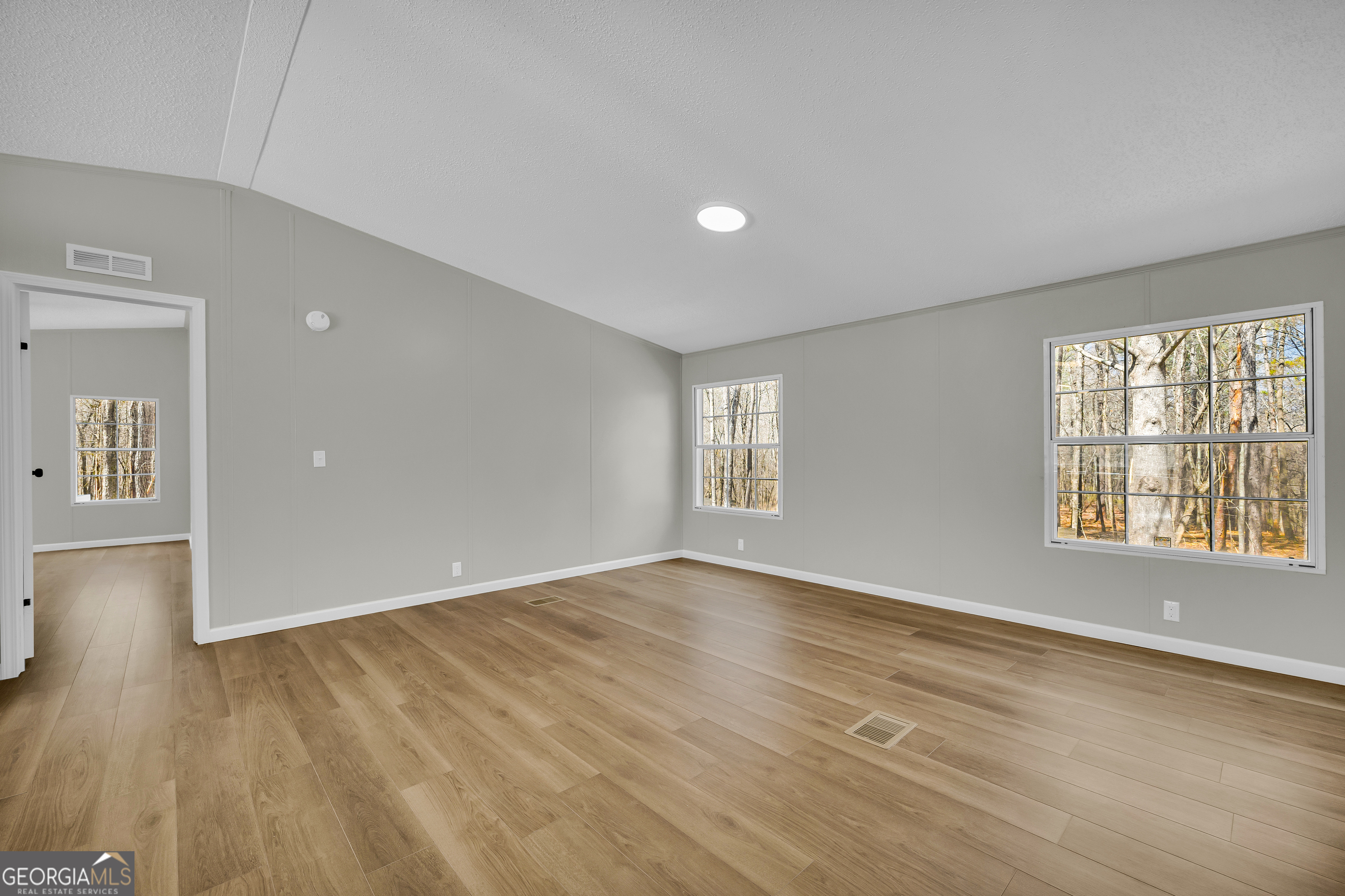 60 Tribble Bottoms Road Arnoldsville, GA 30619 - Photo 30 of 66 a view of an empty room with wooden floor and a window