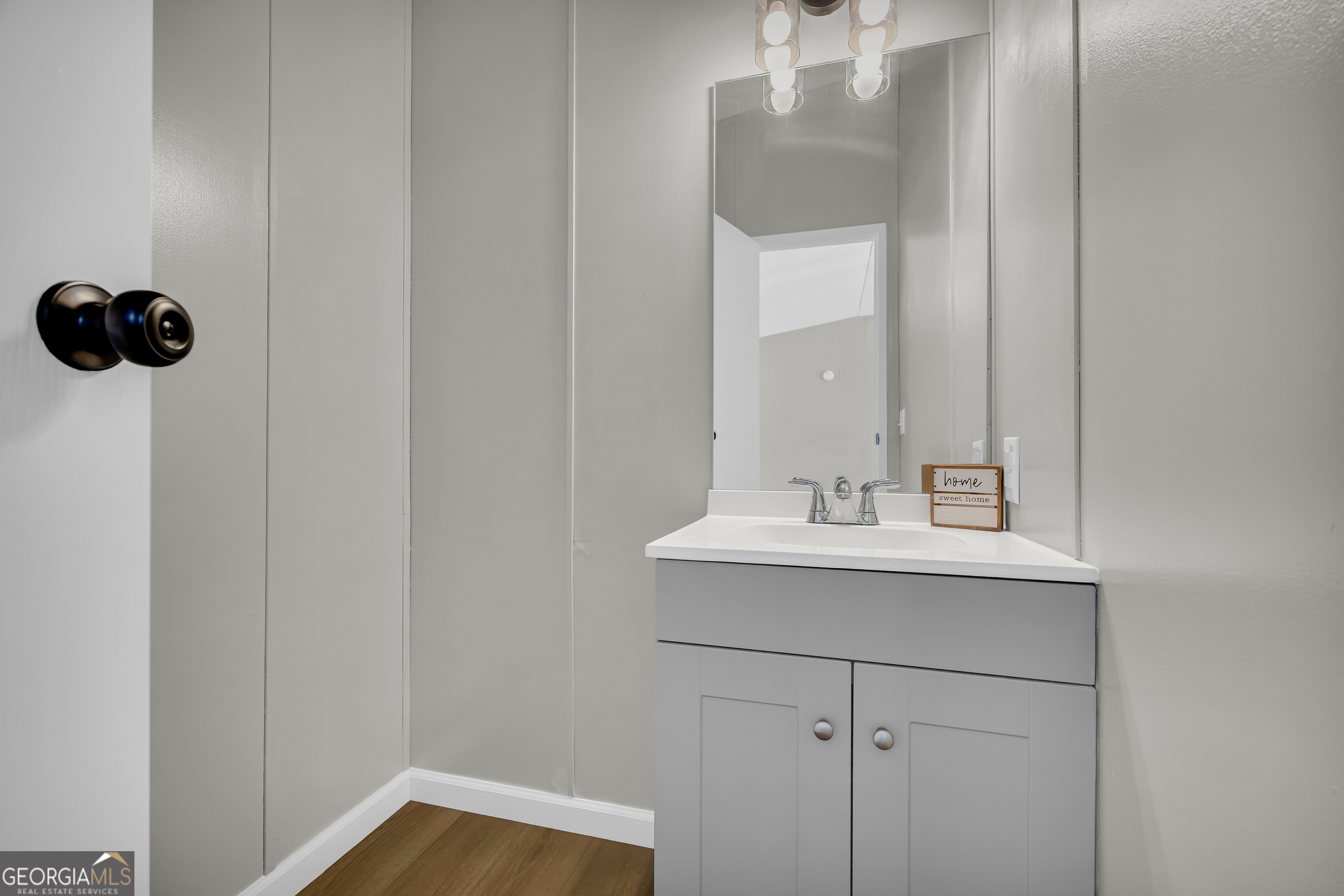 60 Tribble Bottoms Road Arnoldsville, GA 30619 - Photo 31 of 66 a bathroom with a sink a mirror and vanity